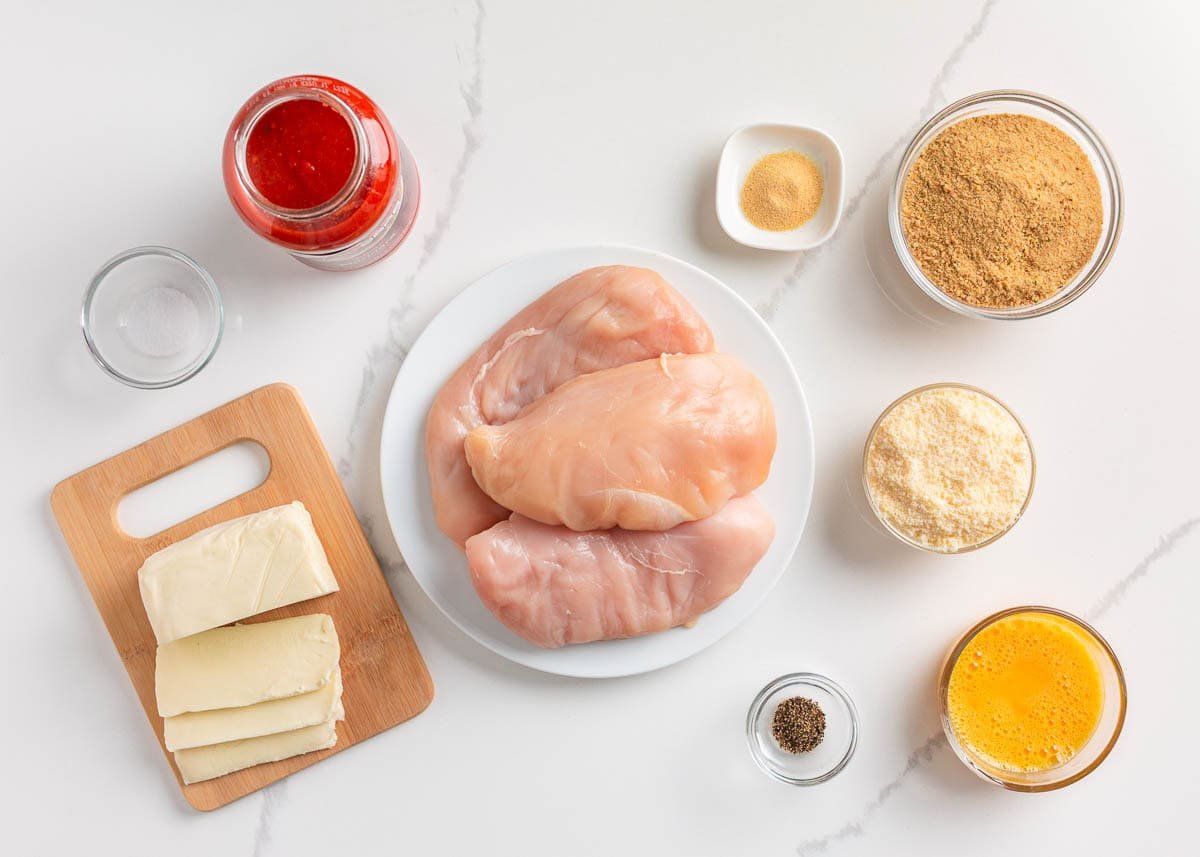 Baked chicken parmesan recipe ingredients on the counter.