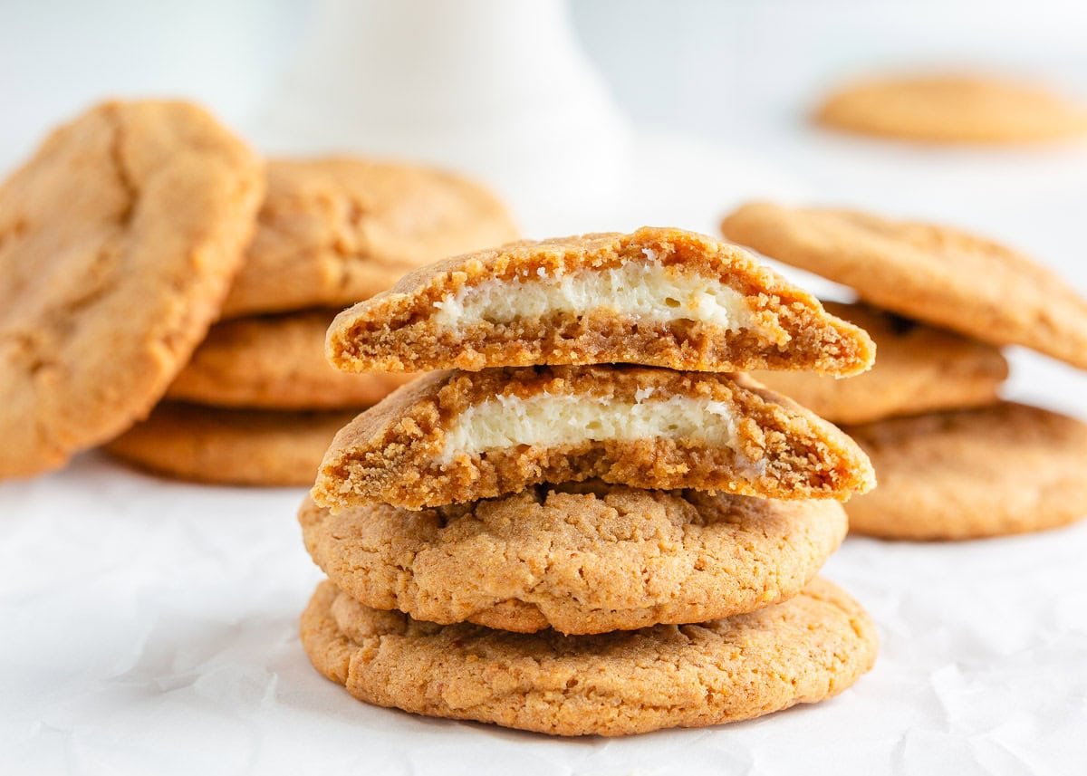 A stack of three cheesecake stuffed cookies on the counter.