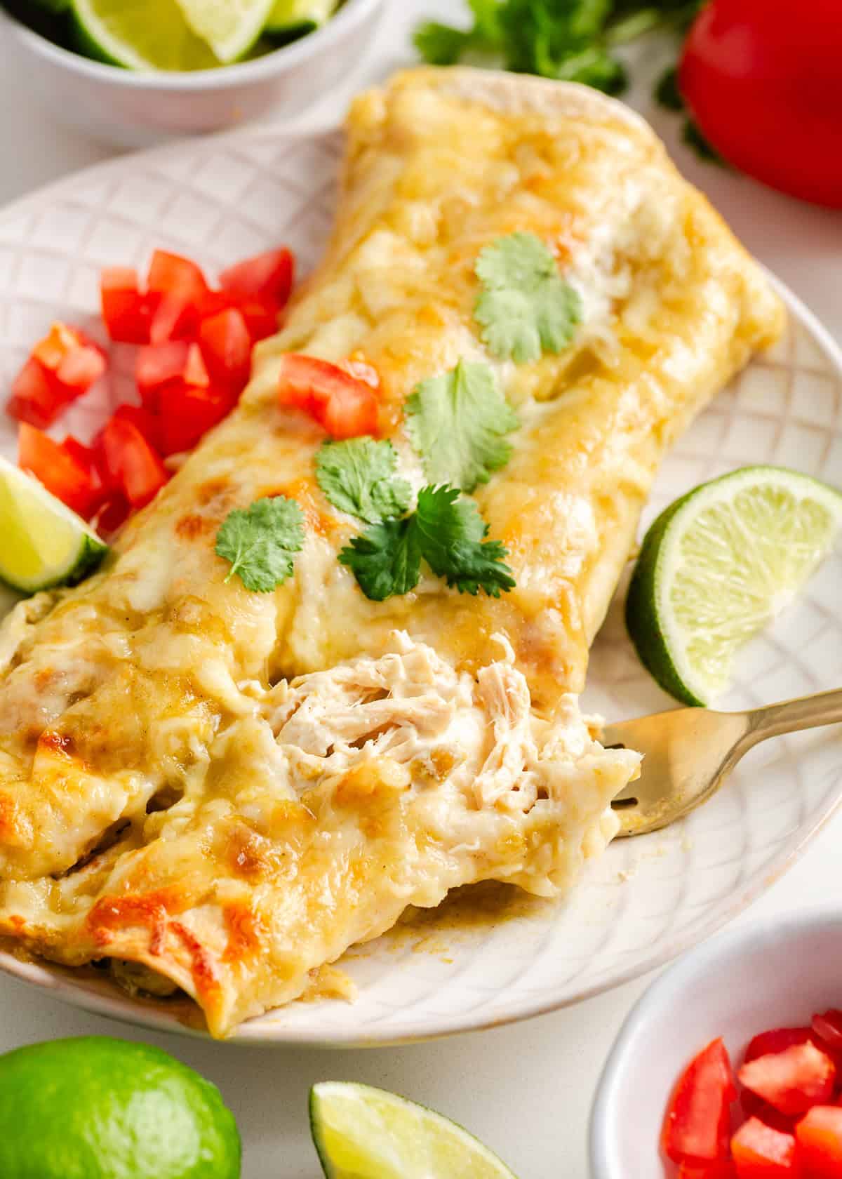 Cream cheese chicken enchiladas on a plate.