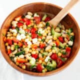 Dense bean salad in a wooden bowl.