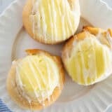 Three crescent roll cream cheese danish on a plate.
