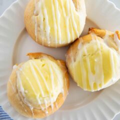 Three crescent roll cream cheese danish on a plate.