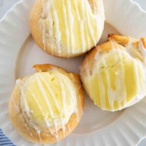 Three crescent roll cream cheese danish on a plate.