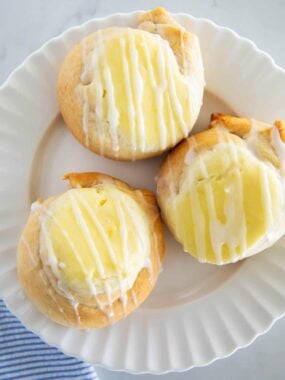Three crescent roll cream cheese danish on a plate.