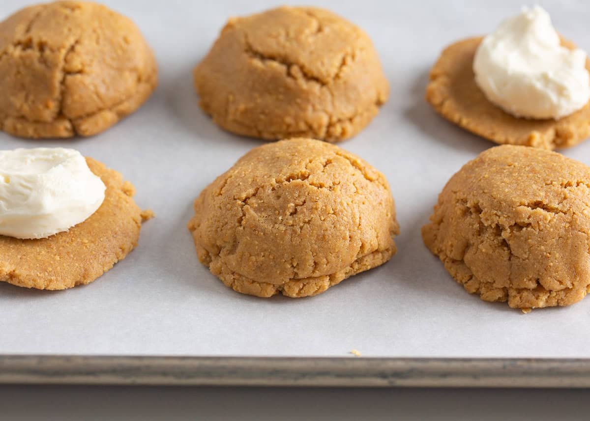 Showing how to fill a cheesecake stuffed cookie.