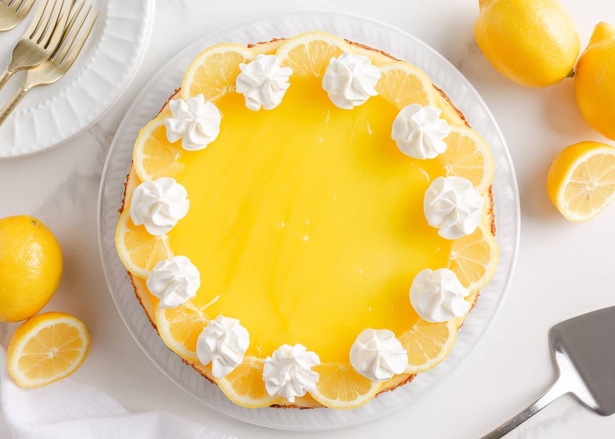Lemon cheesecake topped with lemon curd and whipped cream.