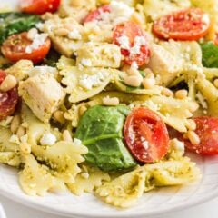 Chicken pesto pasta salad on a white plate.
