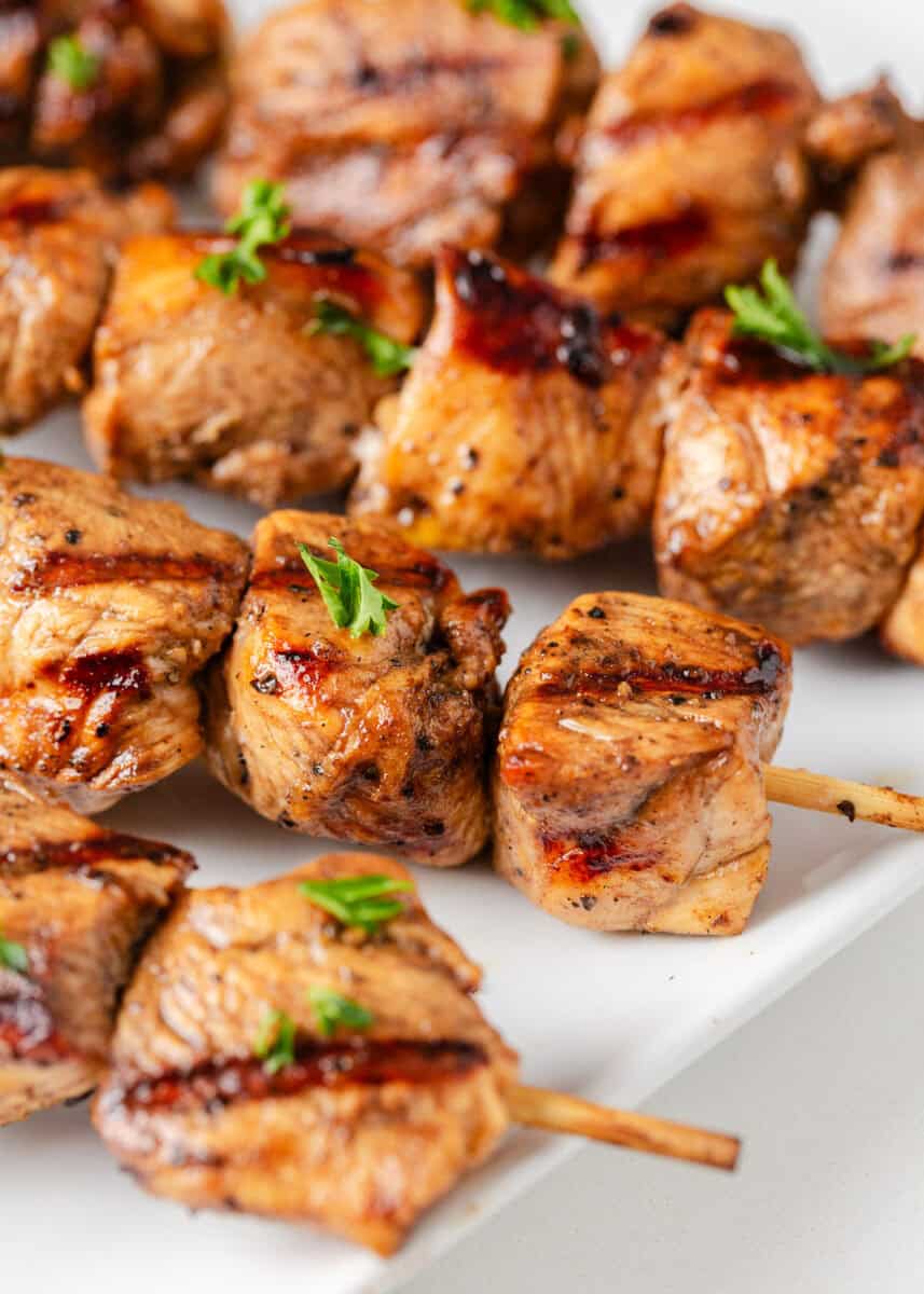 Chicken skewers on a plate.