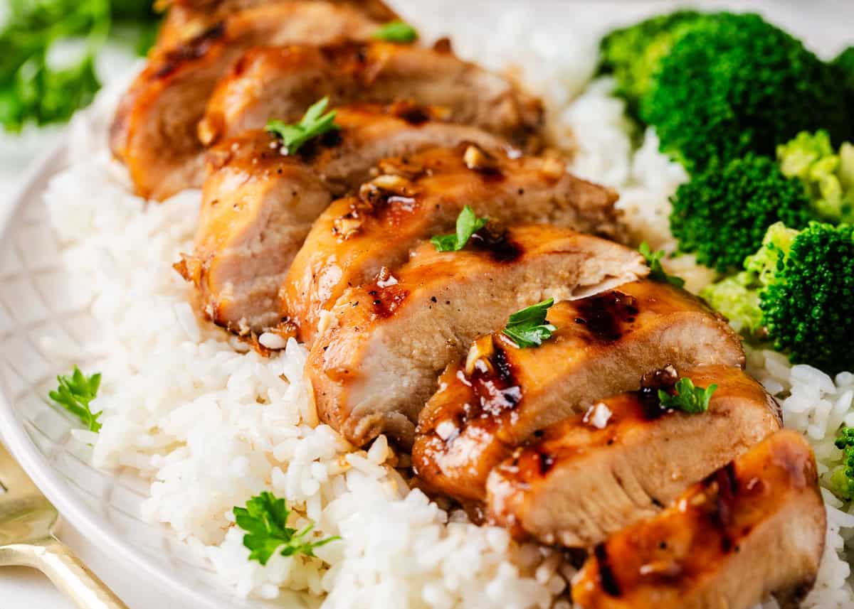 This honey garlic chicken starts with a sweet and savory honey garlic marinade and ends with juicy, caramelized flavor from the grill! Sliced grilled honey garlic chicken breast.