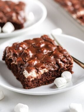 A slice of Mississippi mud cake on a white plate.
