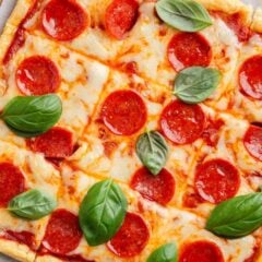 Puff pastry pizza with pepperoni and basil.