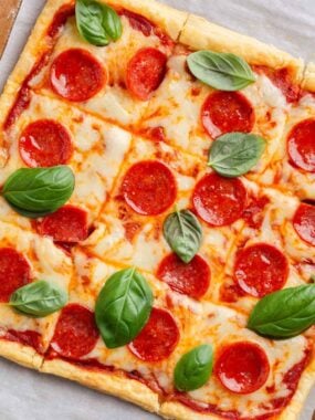 Puff pastry pizza with pepperoni and basil.
