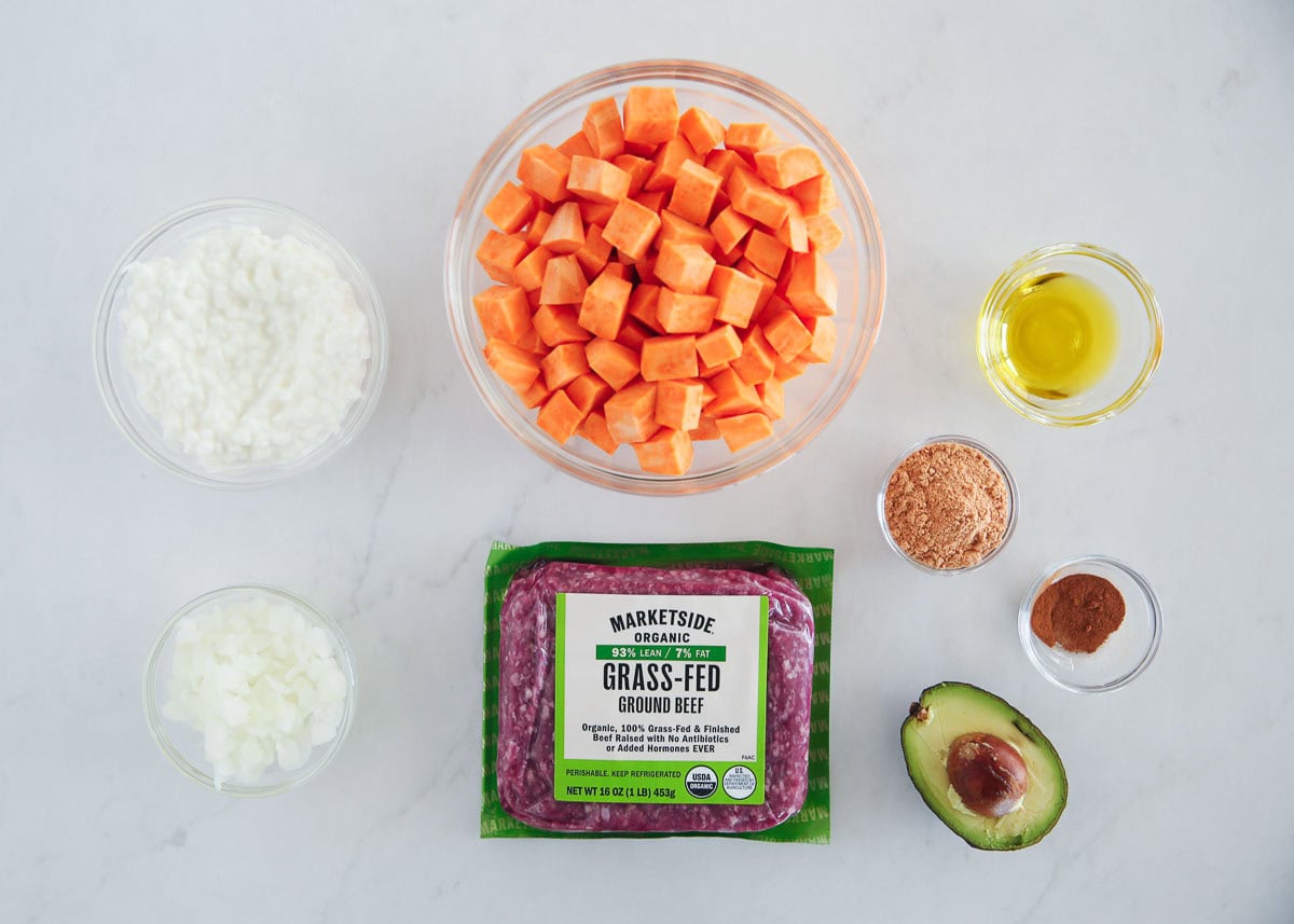 Ground beef, sweet potatoes, cottage cheese, avocado, onion, taco seasoning and cinnamon on the counter.