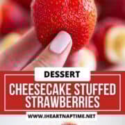 A bowl of cheesecake stuffed strawberries and a hand holding one.