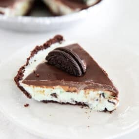 A slice of grasshopper pie made with mint ice cream on a plate.