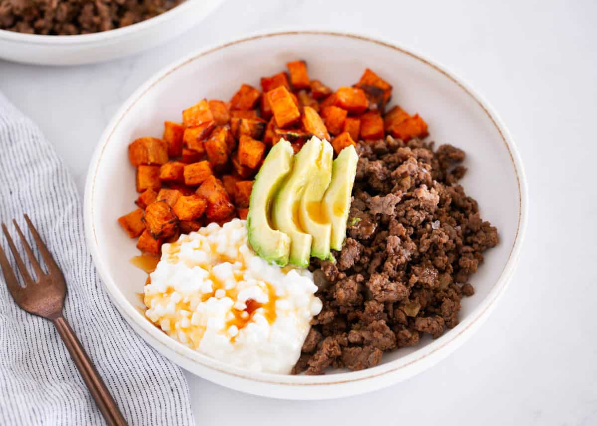 This viral TikTok cottage cheese sweet potato beef bowl is packed with protein and bold hot honey flavor. A sweet and spicy dinner that's ready in just 30 minutes! Hot honey ground beef bowl with sweet potatoes, avocado and cottage cheese.