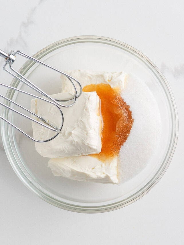 Cream cheese, vanilla and sugar in a mixing bowl with beaters.