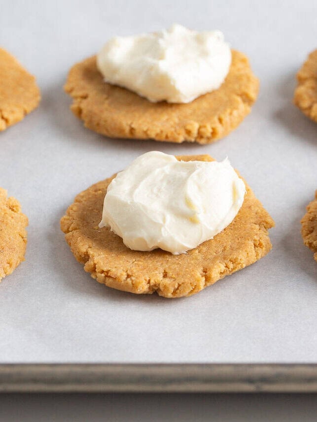 Cheesecake filling set on top of a cookie bottom.