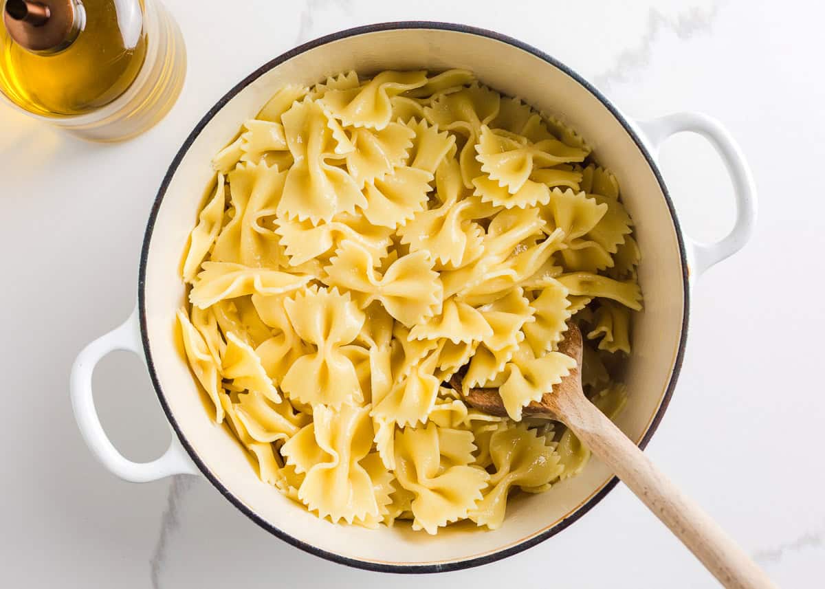 Cooked bow tie pasta in a pot.
