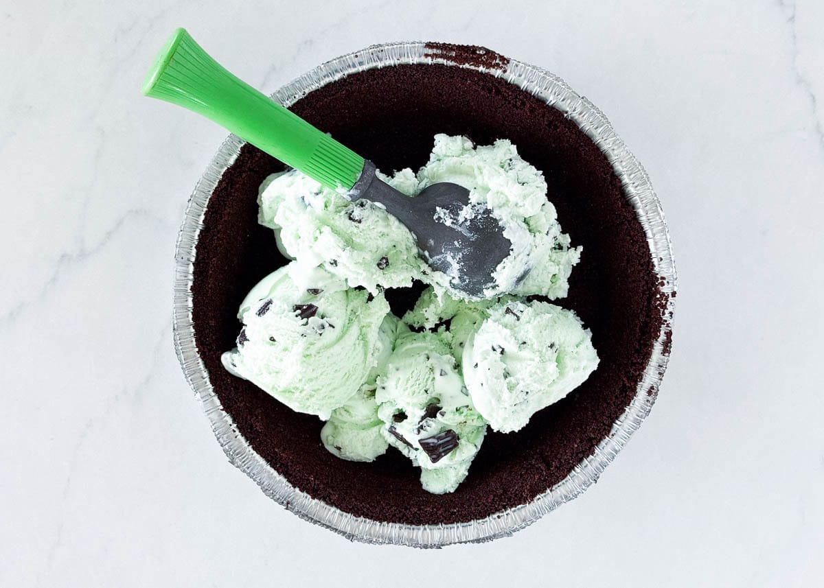Add softened mini chip ice cream to an Oreo pie crust.