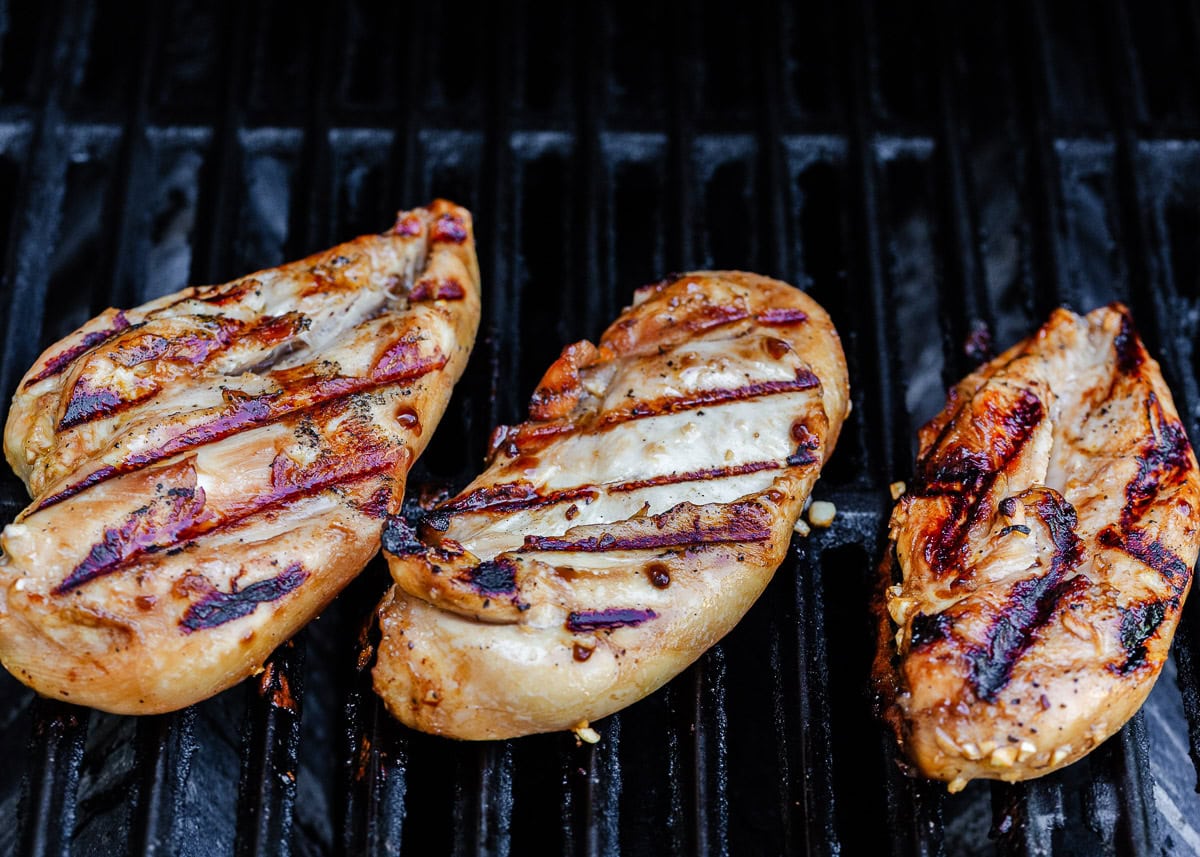 Honey garlic chicken breasts on grill.