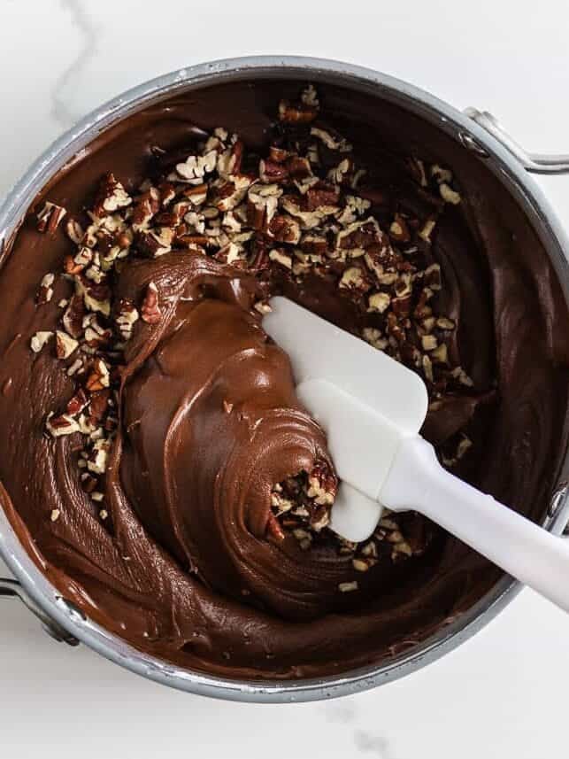 Chocolate icing with pecans in a pot.