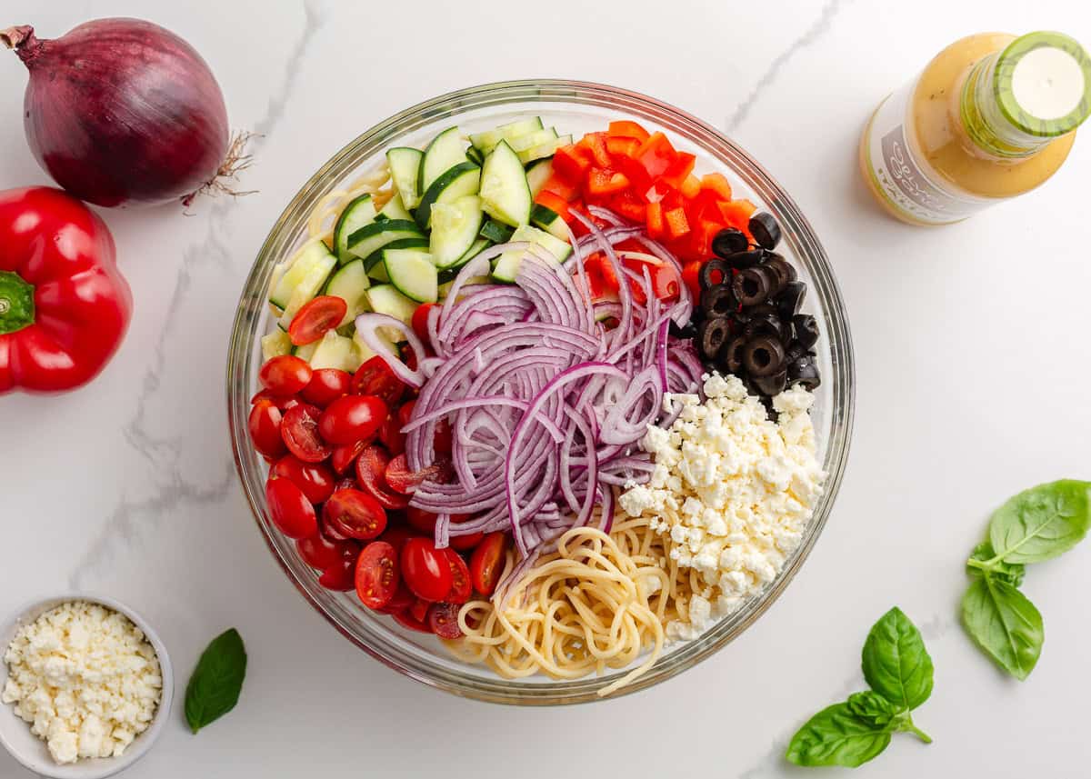 Ingredients in a bowl for spaghetti pasta salad.