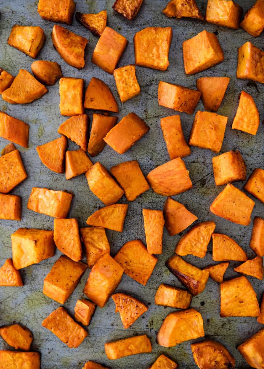 Crispy roasted sweet potato cubes for a hot honey beef bowl recipe.
