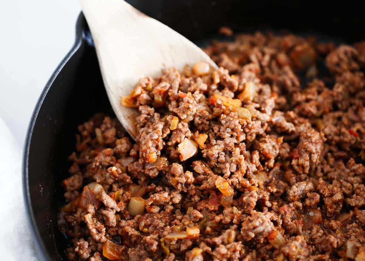 Seasoned ground beef cooked with onion for a sweet potato beef bowl recipe.
