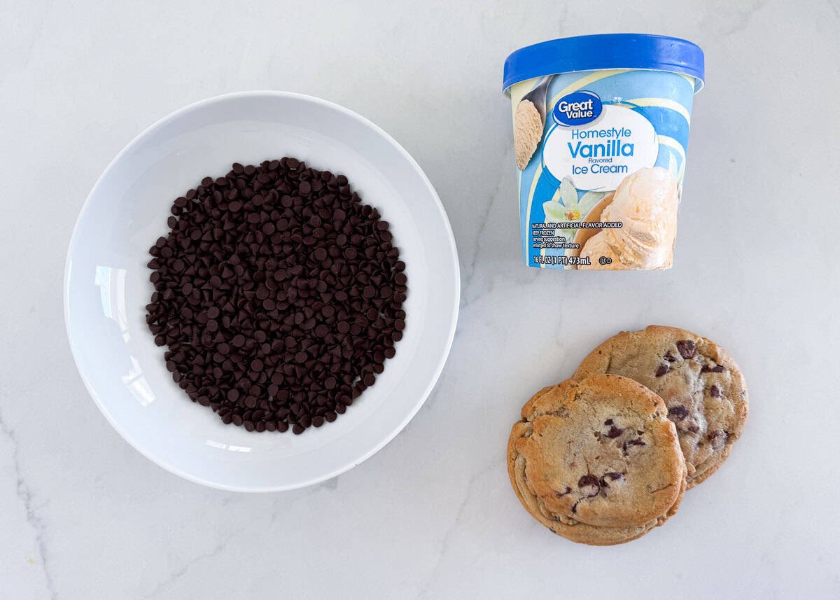 Cookie Ice Cream Sandwiches ingredients including chocolate chip cookies, mini chocolate chips and vanilla ice cream on the counter.