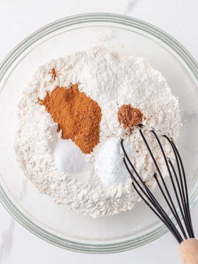 Whisking dry ingredients in a bowl.