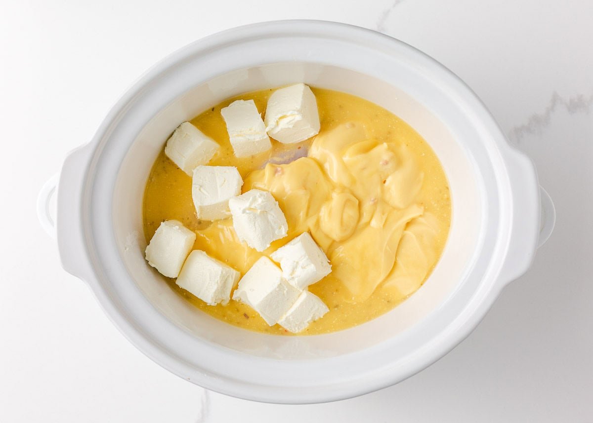 Olive Garden chicken pasta combines tender chicken slow-cooked in a rich, creamy, zesty sauce served over your favorite pasta, for the perfect weeknight meal at home! Crockpot filled with chicken, cream cheese, and cream of chicken soup for Olive Garden chicken pasta.