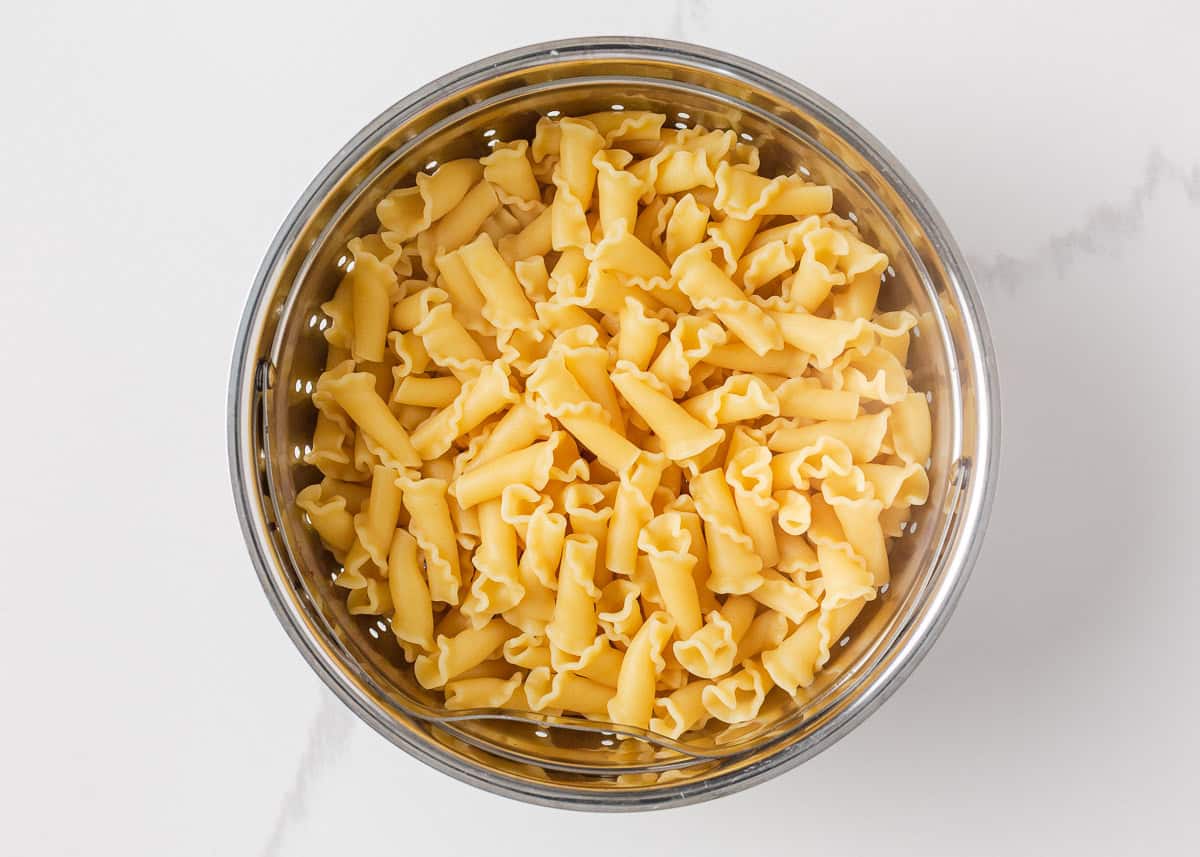 Cooked campanelle pasta drained in a colander for making easy lasagna casserole.