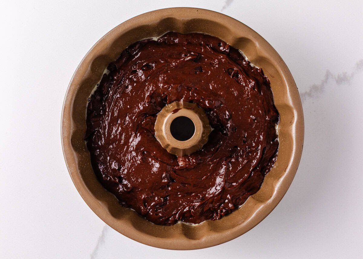 Chocolate cake batter in a bundt pan.
