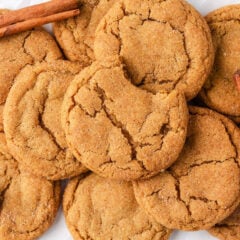 Flat lay of golden maple chewy pumpkin cookies made with brown butter showing crinkled tops and cinnamon sugar coating.