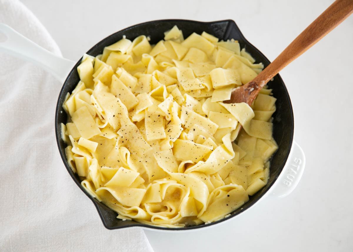 These classic buttered noodles are rich, garlicky, and tossed with fresh Parmesan for the perfect cozy bite. Ready in just 20 minutes, they are an easy side dish or weeknight dinner! Butter noodles in a skillet.
