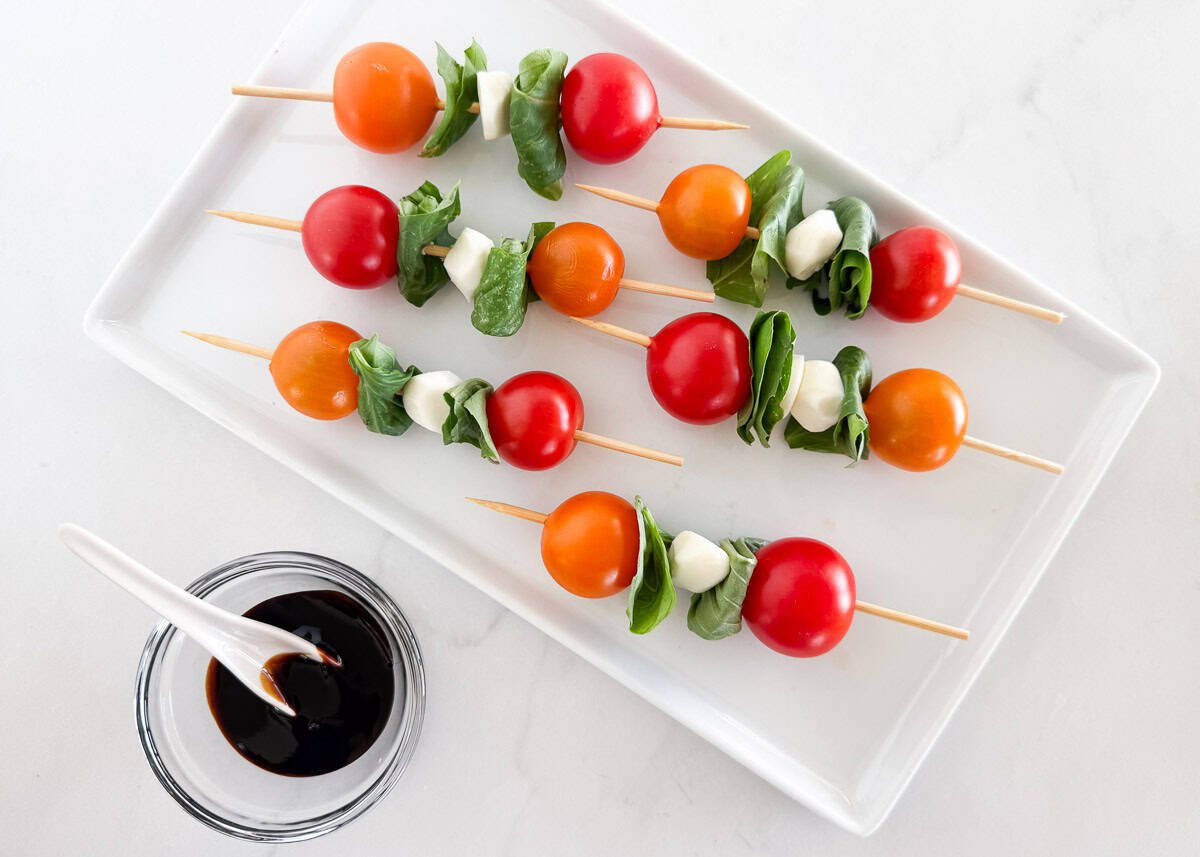 Showing how to make caprese skewers.