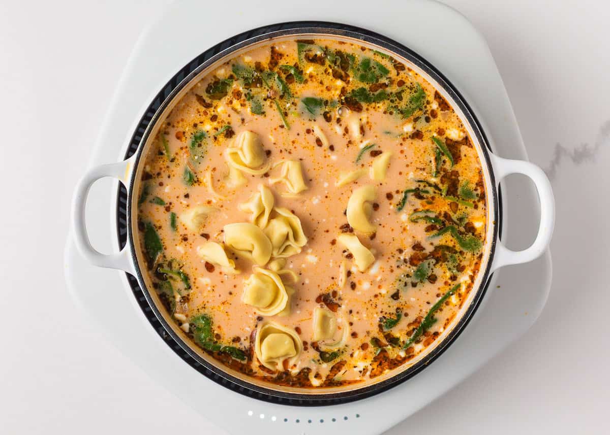 Cheese tortellini added to the creamy Italian sausage soup near the end of cooking.