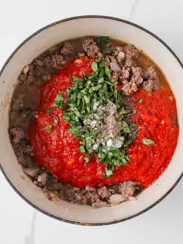 Ground beef cooked with marinara sauce, fresh basil, and spices for lasagna casserole filling.