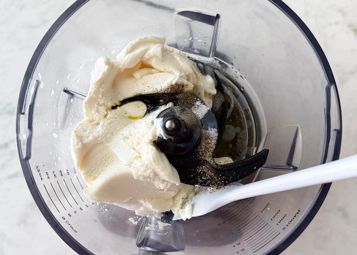 Showing how to make whipped ricotta in a food processor.