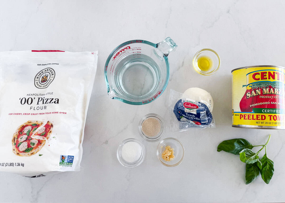 Margherita pizza ingredients on the counter.