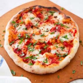 Margherita pizza on a pizza wheel.