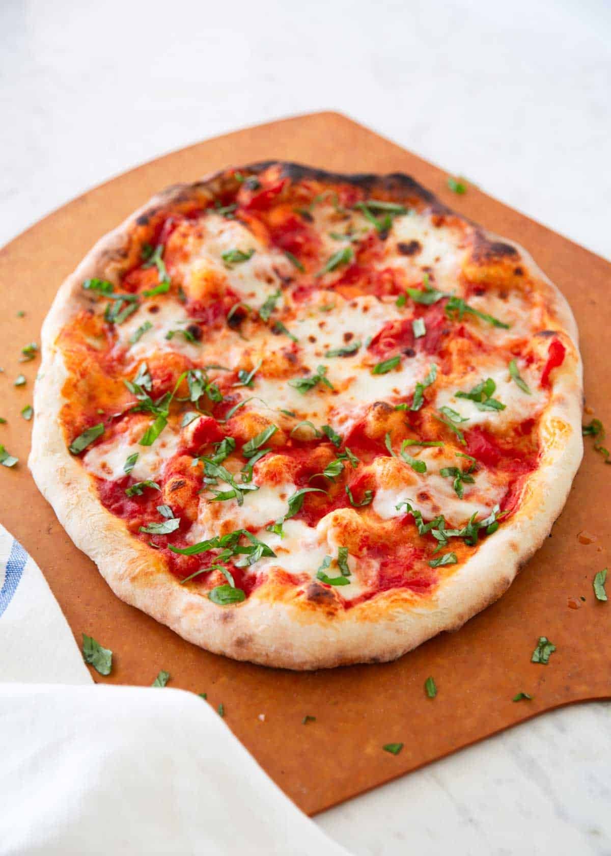 Margherita pizza on a pizza wheel.