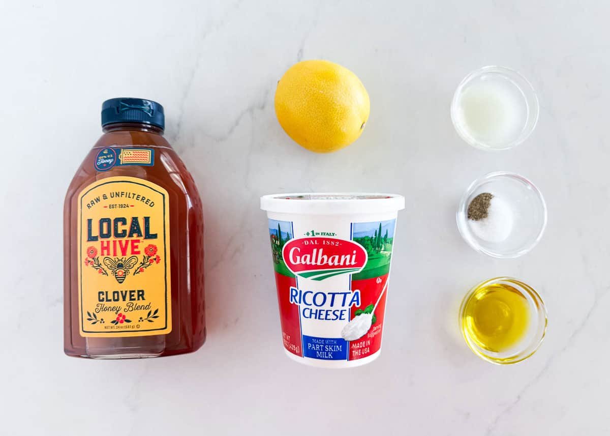 Whipped ricotta dip ingredients including olive oil, ricotta, lemon, salt and pepper and honey.