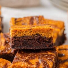 Close-up of a pumpkin brownie showing distinct pumpkin and chocolate brownie layers with a fudgy texture.