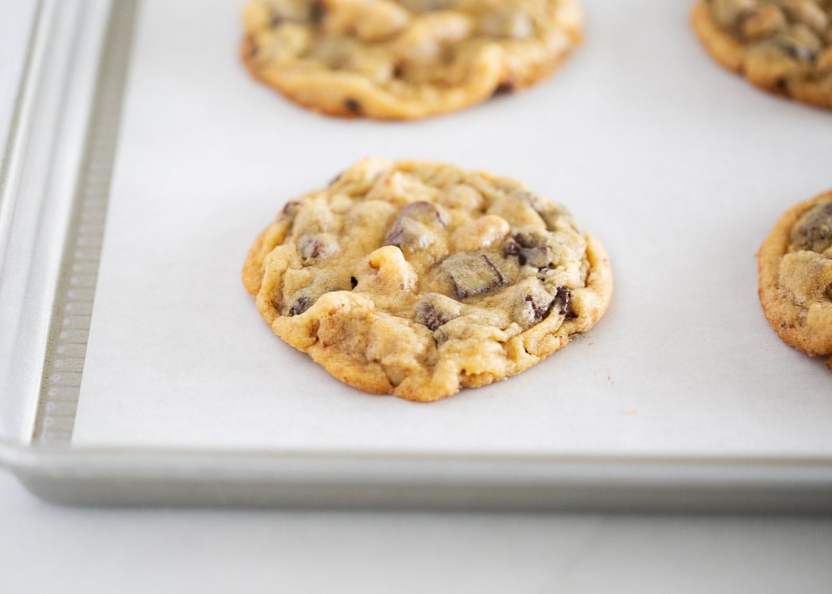 Chewy chocolate chip walnut cookies made with rich brown sugar, melty chocolate chunks plus chocolate chips, and crunchy walnuts. A bakery-style treat made at home! Chocolate chip walnut cookies on a baking sheet.
