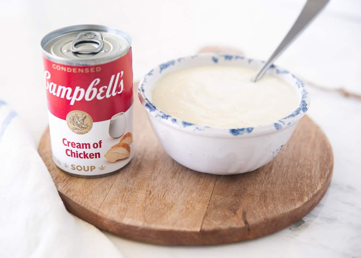 Ditch the can and make creamy, homemade cream of chicken soup with simple, wholesome ingredients. Ready in just 10 minutes to use in casseroles and more! Homemade cream of chicken soup in a bowl with a can of Campbell's condensed to the side of the bowl.