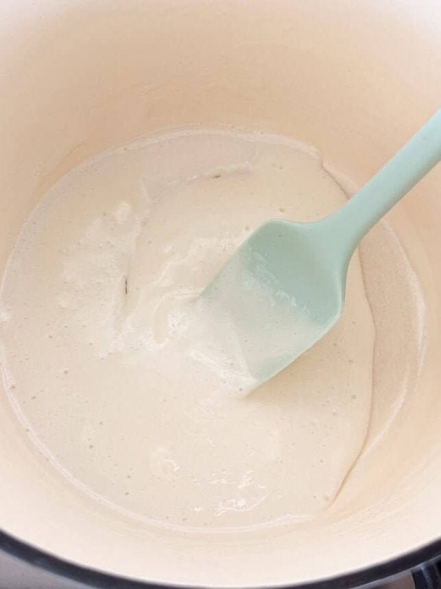 Mixing cream in a pot.