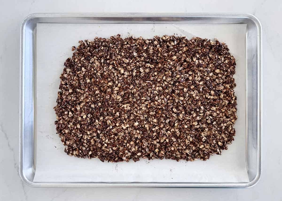 Chocolate granola on a baking sheet.