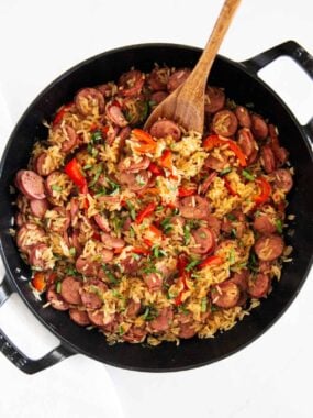 Homemade sausage and rice skillet cooked in one pot with sliced sausage, peppers, and rice.